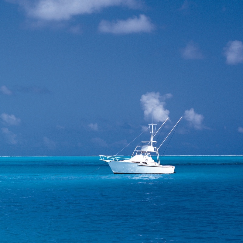 Boat far away under a blue sky